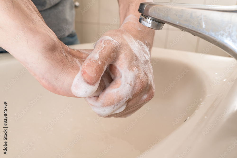 Hygiene concept. Washing hands with soap under the faucet with water Hygiene concept. Washing hands with soap under the faucet with water