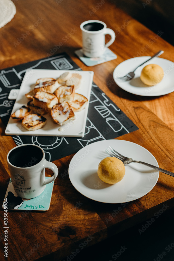 Table setting for breakfast - Plate, fork, cup and toast on the wooden table. Table setting for breakfast - Plate, fork, cup and toast on the wooden table.