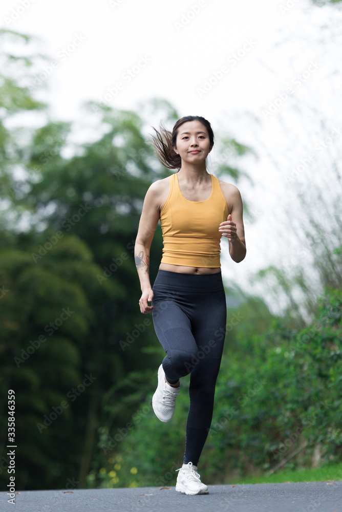 A young Asian woman is running A young Asian woman is running