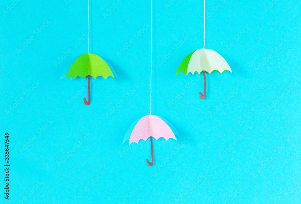 blue background with an umbrella on a rope of paper