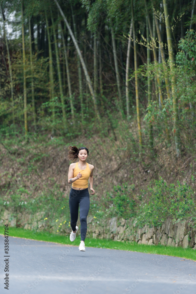 A young Asian woman is running A young Asian woman is running