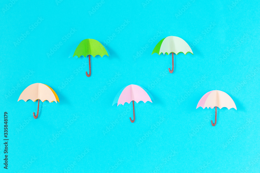 blue background with five umbrellas of paper, handmade