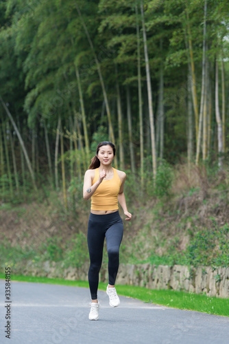 A young Asian woman is running