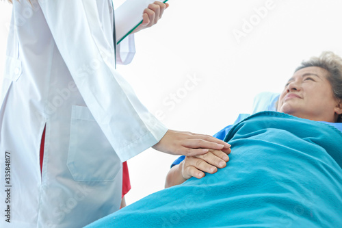 Asian doctor having checkup for a senior patient taken by soft focus technique