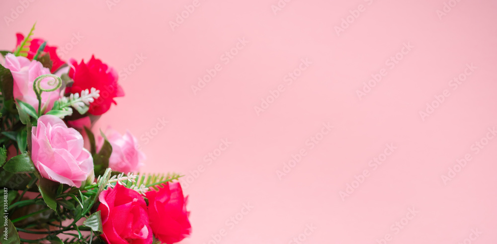 Fototapeta premium A bouquet of roses lies on a pink background: a banner, a place for text, a romantic concert for Valentine's day