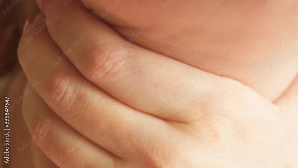 pain and dryness in the throat the first signs of the disease, a woman touches her throat with her hand, close-up pain and dryness in the throat the first signs of the disease, a woman touches her throat with her hand, close-up
