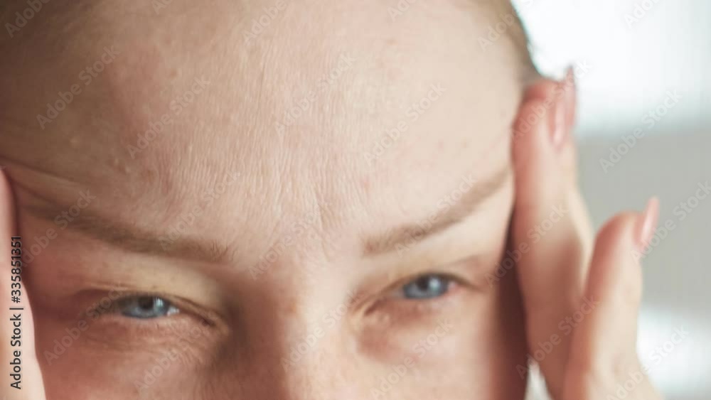 headache, signs of illness, woman rubbing her temples, close-up headache, signs of illness, woman rubbing her temples, close-up