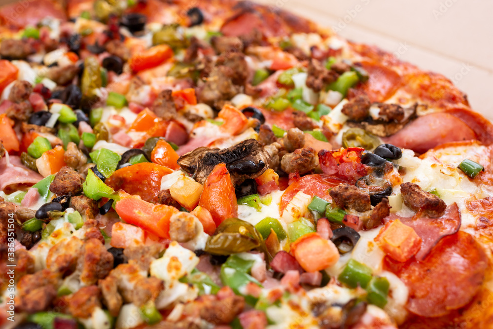 A closeup view of a deluxe topping pizza pie. A closeup view of a deluxe topping pizza pie.