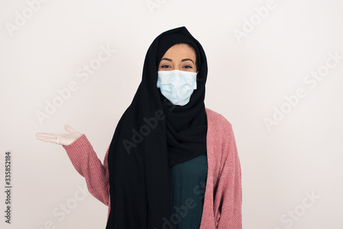 Positive glad female says: wow how exciting it is, has amazed expression, shows something on blank space with open hand over isolated background. Advertisement concept.