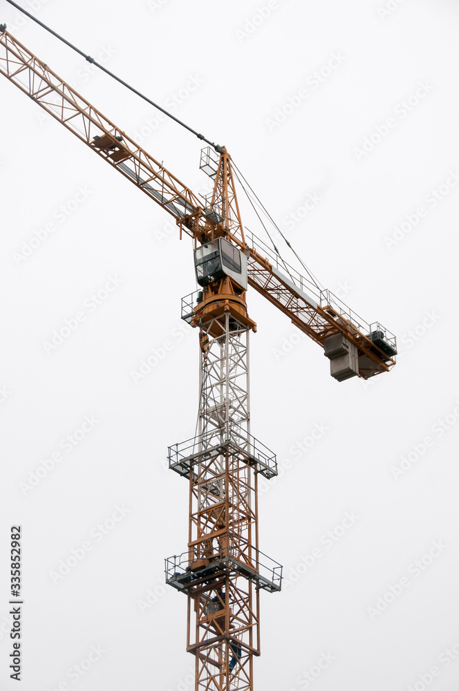 yellow tower crane on the sky background.
