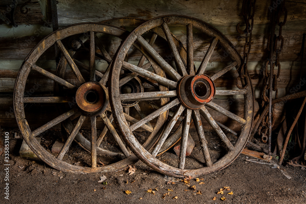 old wooden wagon wheels in shed
