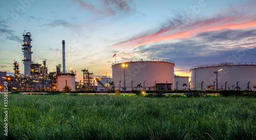 Oil and gas industry, oil refinery industry, refinery form factories, oil storage tanks and steel pipes with sunset background