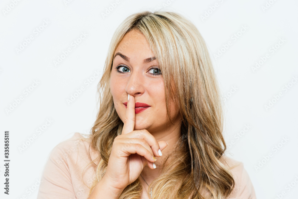 woman put finger on her lips woman put finger on her lips