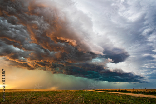 Tableau sur toile storm clouds over a field