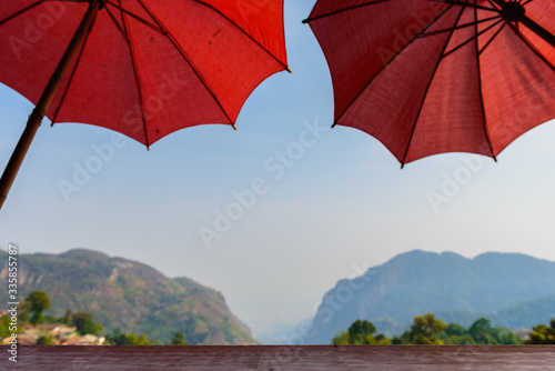 Beautiful landscape, the mountain is a coffee shop with red umbrellas, protecting the sun is the signature of the shop. Chiang Rai province in Thailand , copy space.