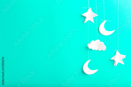 Mint background with new moon, stars and clouds of paper, handmade photo