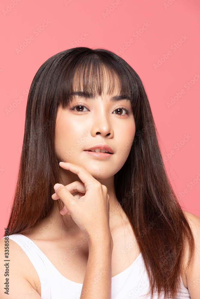 Young Beautiful Asian woman smile touching soft cheek with clean and fresh skin Happiness and cheerful with positive emotional,isolated on pink background,Beauty Cosmetics and spa Treatment Concept Young Beautiful Asian woman smile touching soft cheek with clean and fresh skin Happiness and cheerful with positive emotional,isolated on pink background,Beauty Cosmetics and spa Treatment Concept