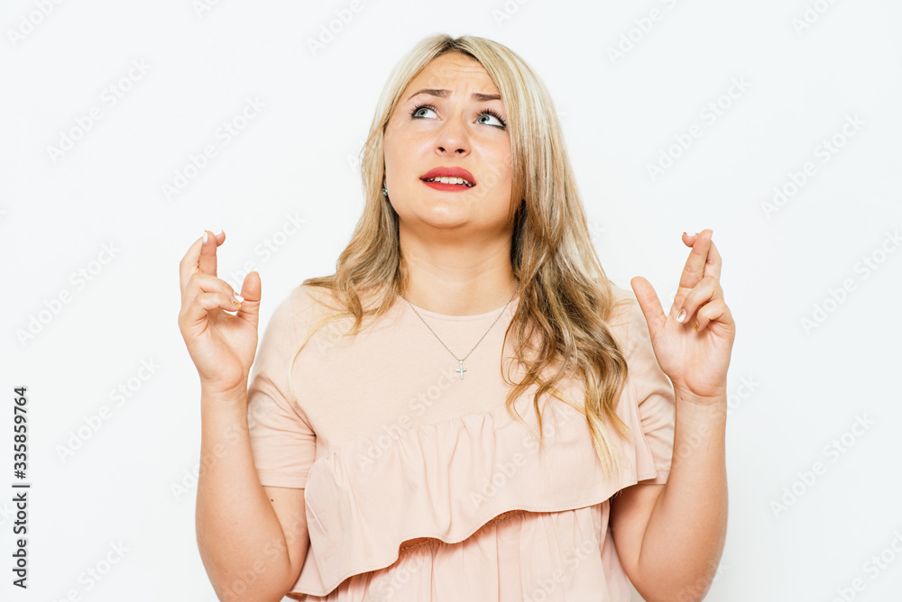 Young woman with fingers crossed Young woman with fingers crossed