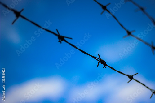 Barbed wire with the sky in the background