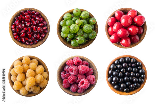 Top view. Fruits and berries in bowl on white background. Fruits with copy space for text. Collage of different fruits and berries isolated on a white background. Fruits and berries isolated on white.