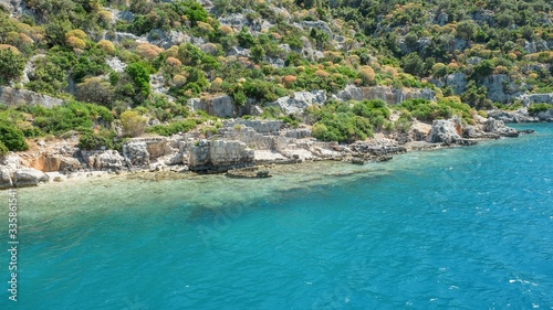 Panoramic view from tourist yacht to weathered ruins of famous ancient underwater town Sunken City on Kekova island, in mediterranean coastline of Antalya province. Popular tourist places in Turkey. © Matrix Reloaded