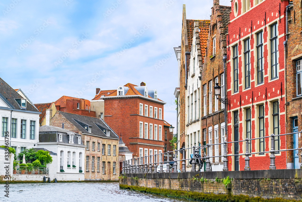 Belgium, Bruges. Street with old houses along the canal.