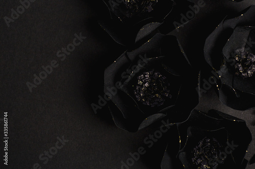 black background with a beautiful gold glittering flowers made of paper
