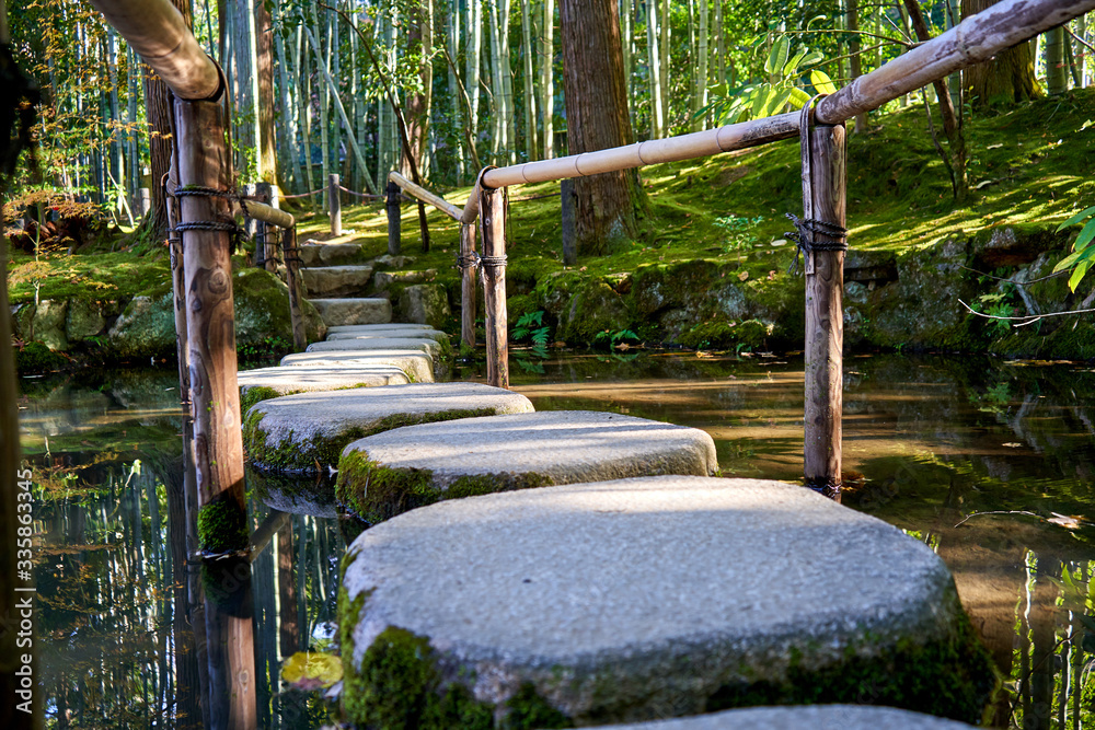 Stone path over the pond in Japanese garden Stone path over the pond in Japanese garden