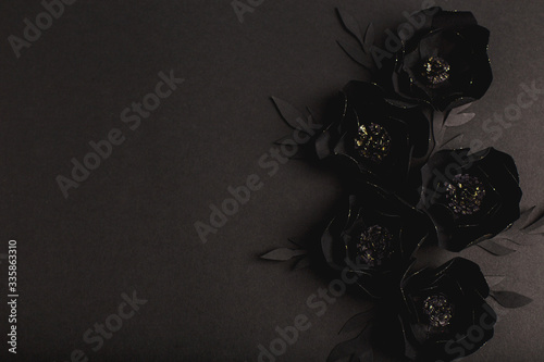 black background with a beautiful gold glittering flowers made of paper