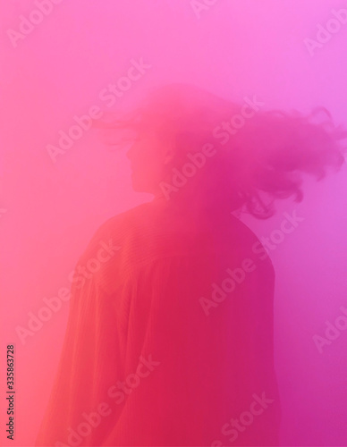 Woman surrounded by pink smoke