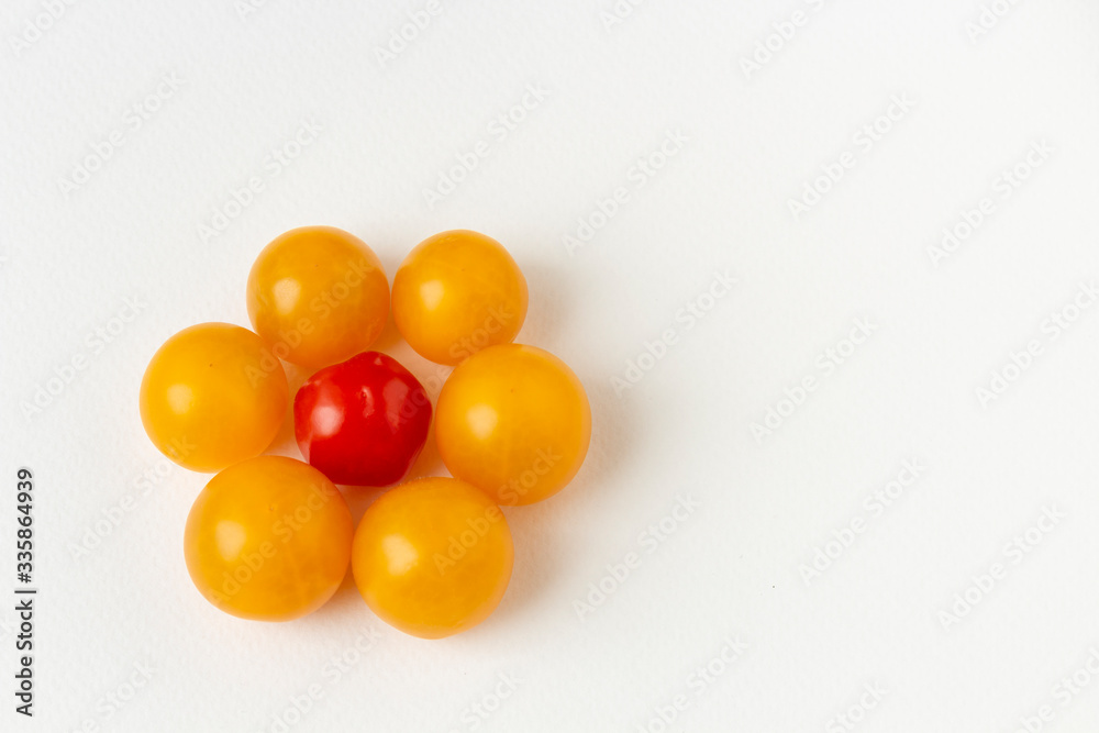 Cherry tomatoes on white paper background. Top view