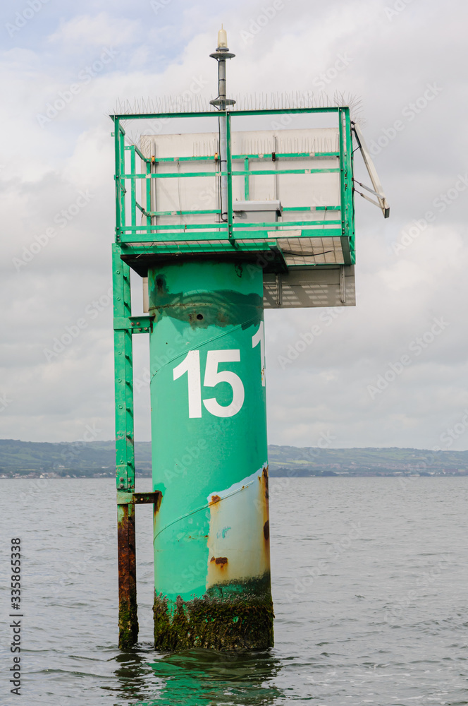Green channel marker with the number 15 in Belfast Lough