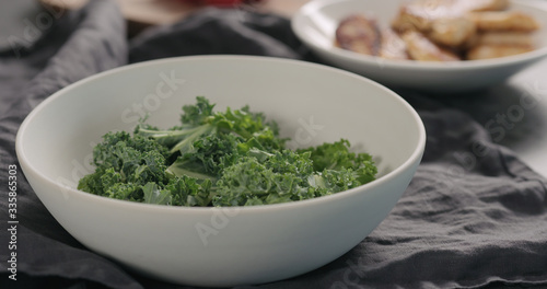 kale leaves in white bowl on countertop
