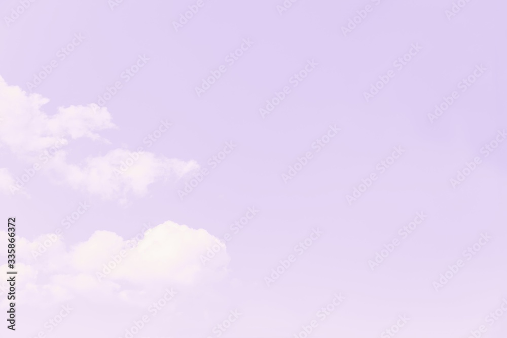 Fototapeta premium Beautiful white soft fluffy clouds on a pale violet sky background