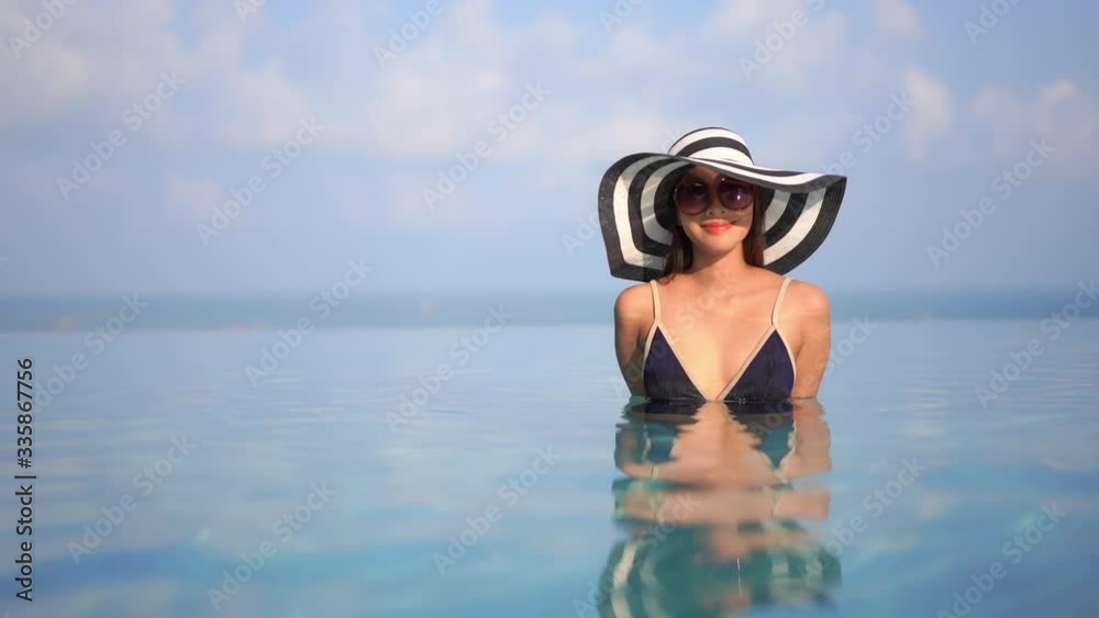 Erotic asian model reflecting on life immersed in a pool Erotic asian model reflecting on life immersed in a pool