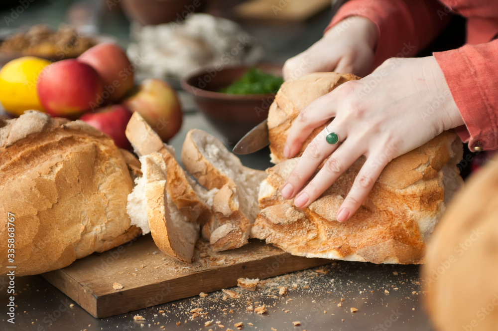 Cutting bread on a wooden Board
