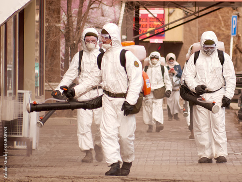 Karaganda, Kazakhstan Meticulous disinfection and decontamination on the streets as a prevention against Coronavirus disease (SARS-Cov-2), COVID-19 outbreak. soldiers in white overalls