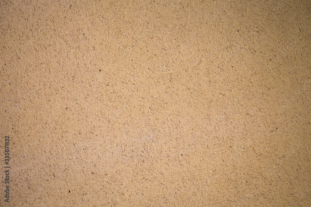 Detail of cement wall texture painted in roasted yellow. Detail of cement wall texture painted in roasted yellow.