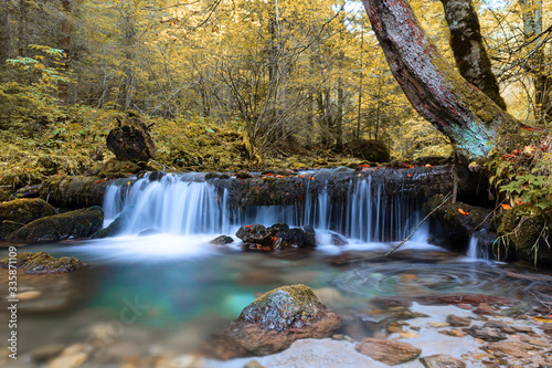 closeup of beautiful waterfall in autumn season photo