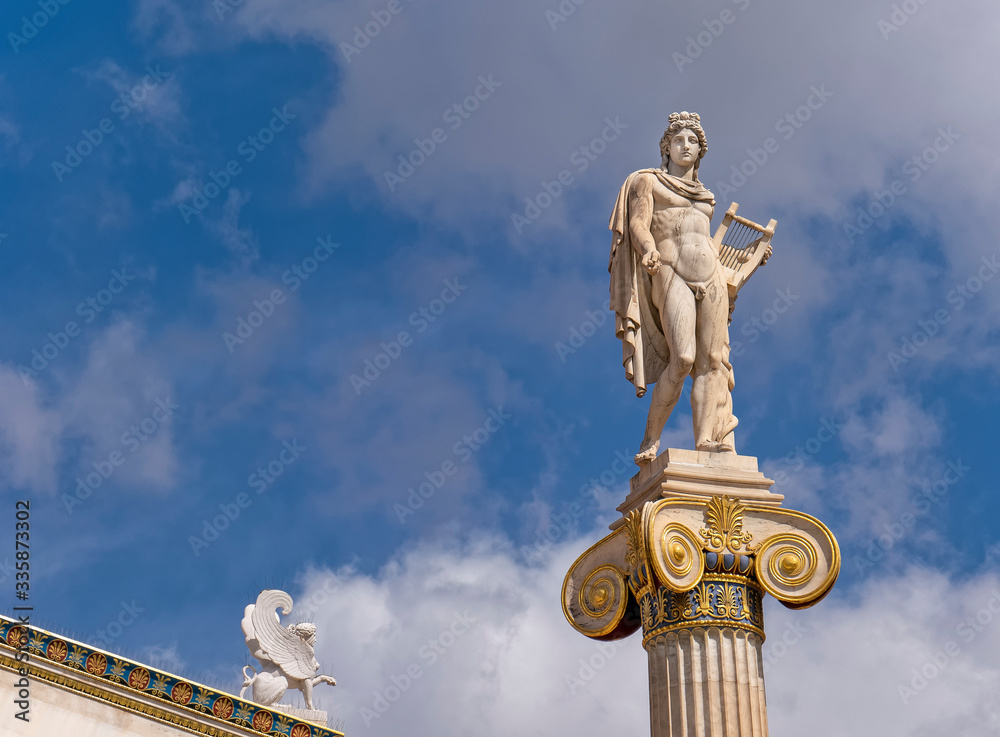 Apollo white marble statue on Ionian style column and small Sphinx under blue sky with some clouds Apollo white marble statue on Ionian style column and small Sphinx under blue sky with some clouds