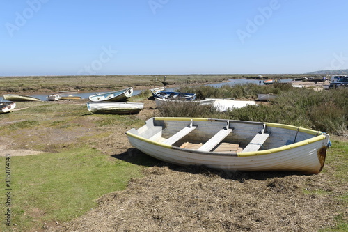 Row boats grounded on a coastal marsh