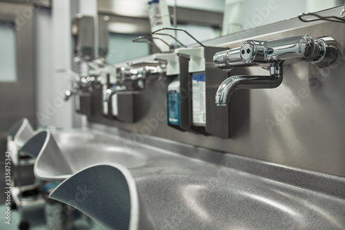 Hand wash room in the hospital. Modern preoperative room for disinfection of disinfection of doctors before surgery. Saving lives, cleanliness is the key to health