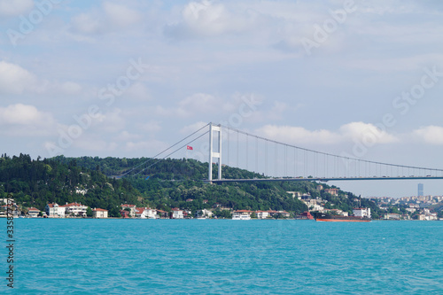 Turquoise Marmara Sea and the Anatolian half of the Fatih Sultan Mehmet Bridge in Istanbul on a cloudy day.