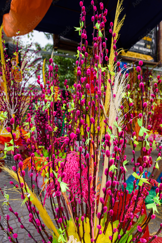 A brightly coloured garish flower display for sale in Hoi An, Vietnam
