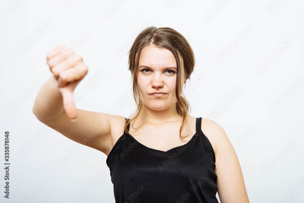 Woman showing a thumb down gesture Woman showing a thumb down gesture