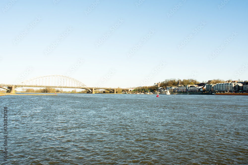 Naklejka premium Cityscape of the city of Nijmegen with the bridge Waalbrug at the river Waal, Netherlands