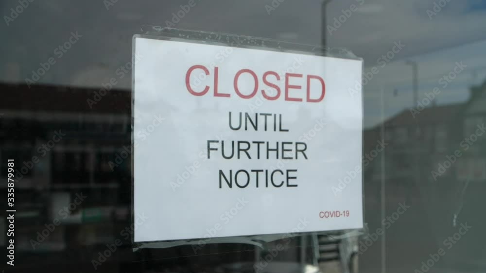 Slow motion dolly out shot of independent shop sign closed until further notice due to the COVID 19 coronavirus pandemic, bars, cafes, restaurants, clubs all shut cause of this international crisis. Slow motion dolly out shot of independent shop sign closed until further notice due to the COVID 19 coronavirus pandemic, bars, cafes, restaurants, clubs all shut cause of this international crisis.