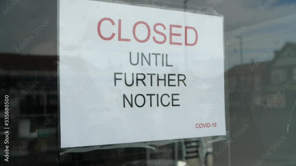 Slow motion pan shot of independent shop sign closed until further notice due to the COVID 19 coronavirus pandemic, bars, cafes, restaurants, clubs all shut cause of this international crisis. Slow motion pan shot of independent shop sign closed until further notice due to the COVID 19 coronavirus pandemic, bars, cafes, restaurants, clubs all shut cause of this international crisis.
