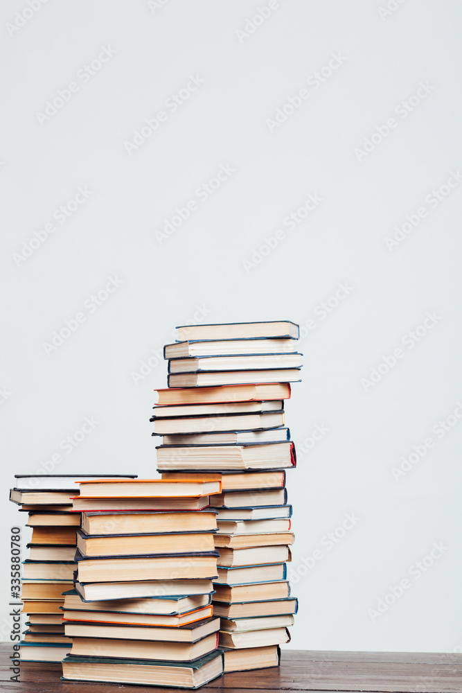 many stacks of educational books at home preparing for exams on a white background many stacks of educational books at home preparing for exams on a white background