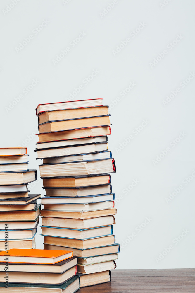 many stacks of educational books at home preparing for exams on a white background many stacks of educational books at home preparing for exams on a white background